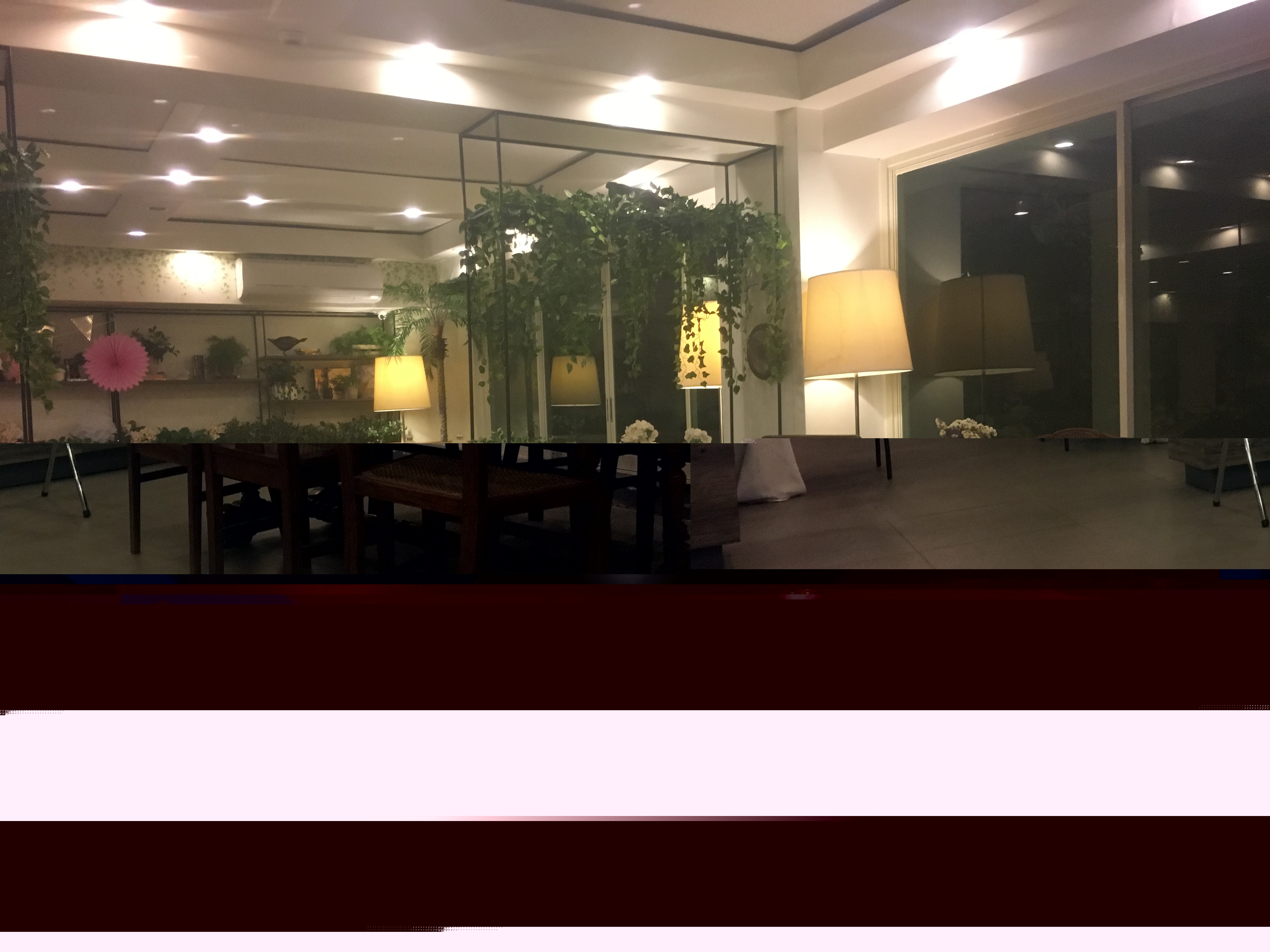 Happy Garden Cafe interior dining area with garden-inspired decor, lush greenery, and warm ambient lighting
